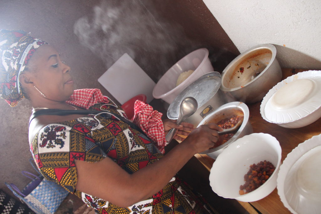 a woman from Rwanda prepares lunch