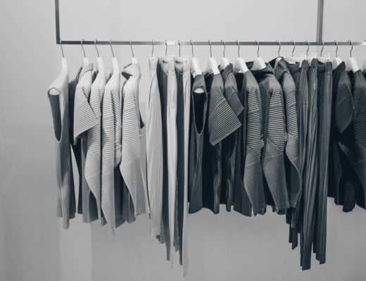 a wardrobe full of white grey and black clothing
