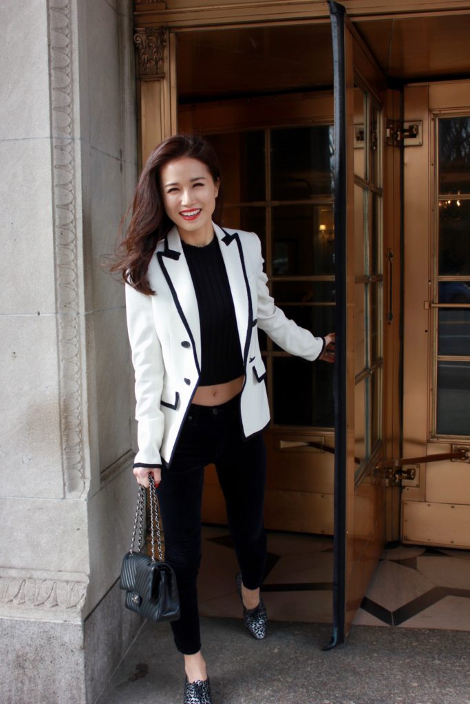 Wardrobe essentials - jinhye edwards models a white blazer with black edging