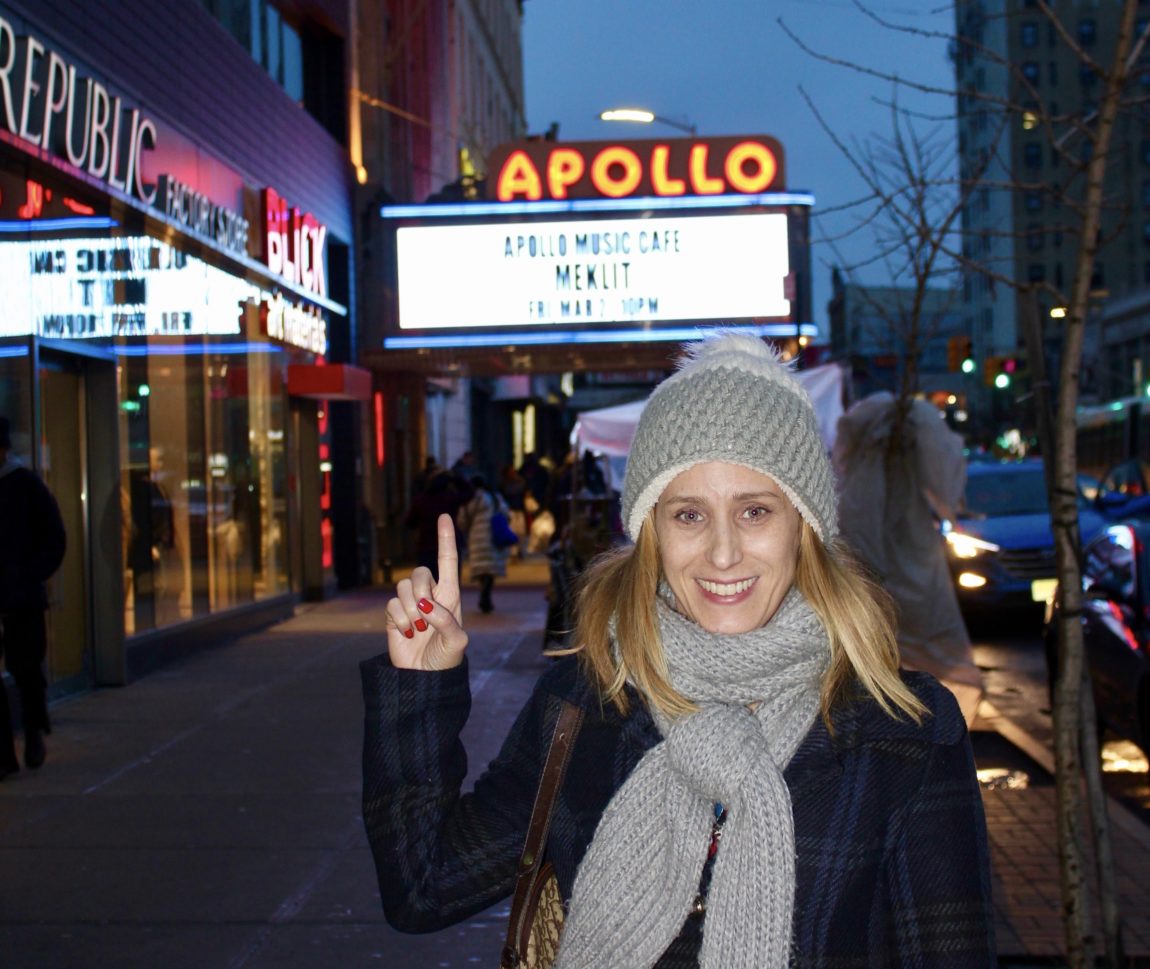 Merry Lerner standing in front of the famous Apollo Theater in Harlem