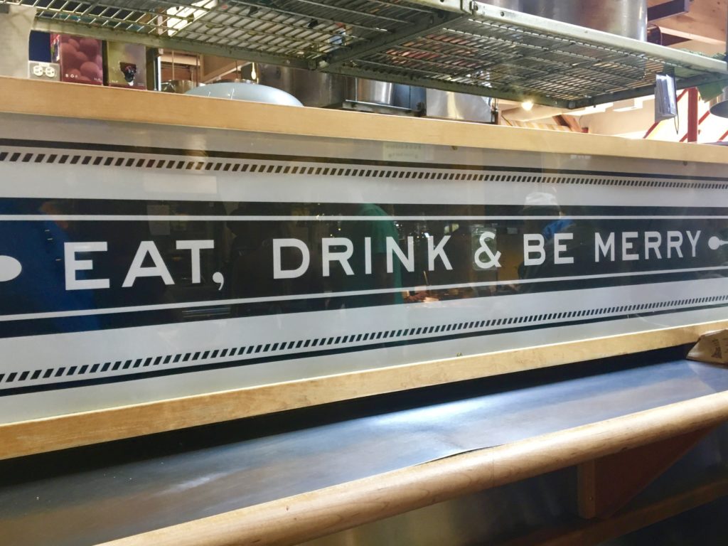 An 'Eat, drink & be Merry' sign at the Granville Island Public Market in Vancouver