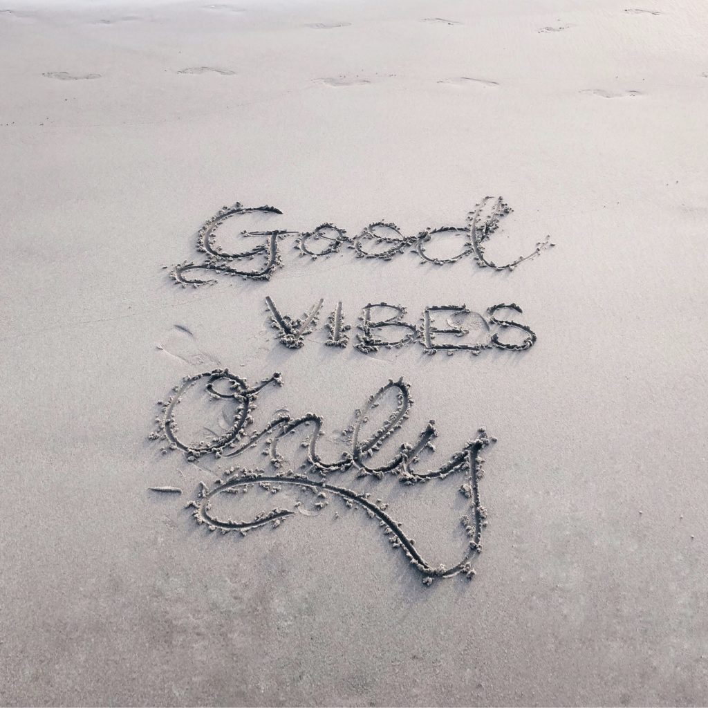 Good vibes only spelled out on the beach