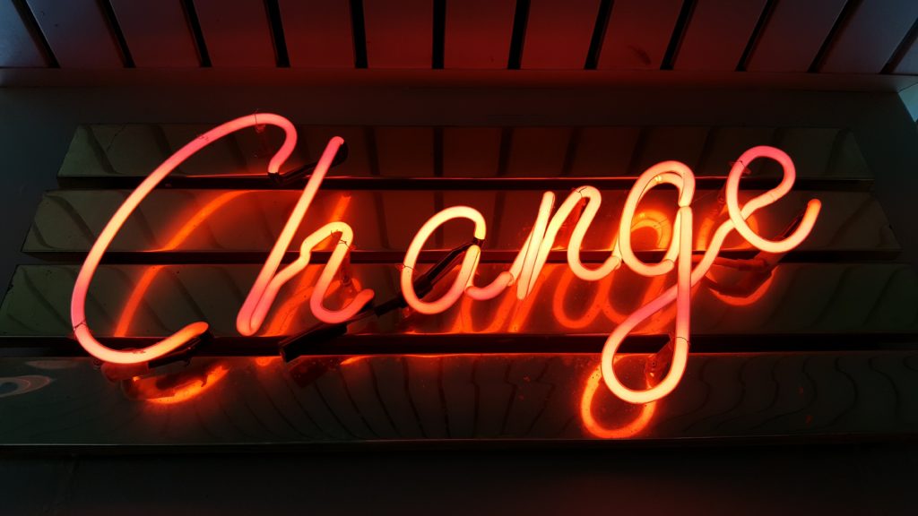 a lit up sign with the word change