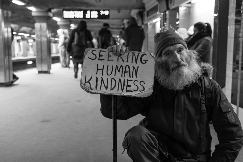 gratitude-guide-man-with-a-sign-seeking-human-kindness