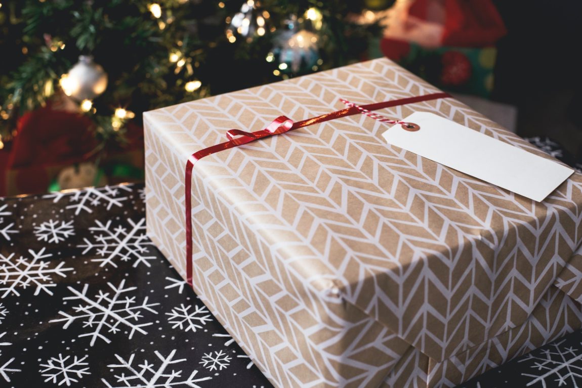 holiday-gifts-under-fifty-dollars-nicely-wrapped-present-by-christmas-tree