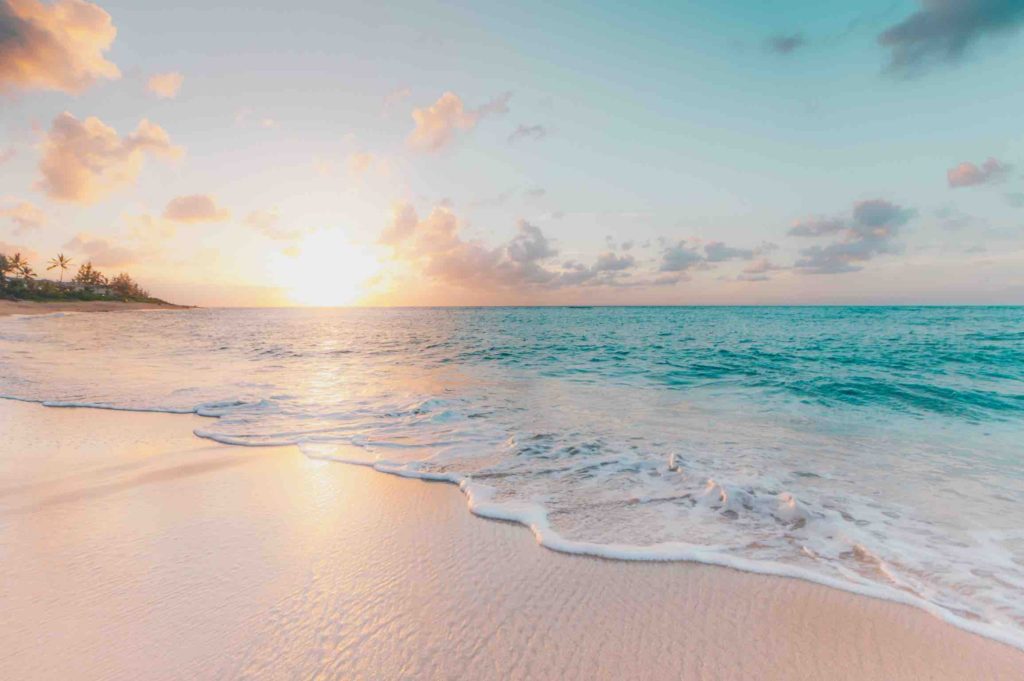 pink-sand-beach-at-sunset-beach-vacation-is-a-travel-trend-for-2021