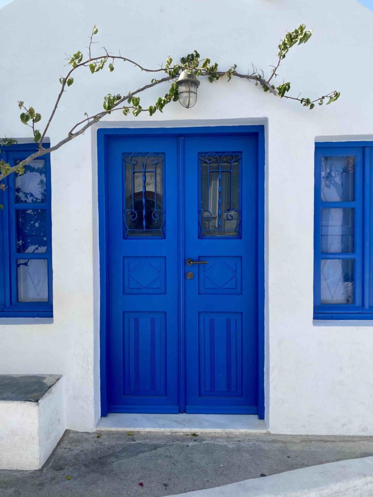 blue-door-white-washed-walls-santorini-greece